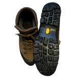 Scarpa GTX vandringskängor för herr i brunt läder, där ena skon visas uppifrån och den andra visar sulan.