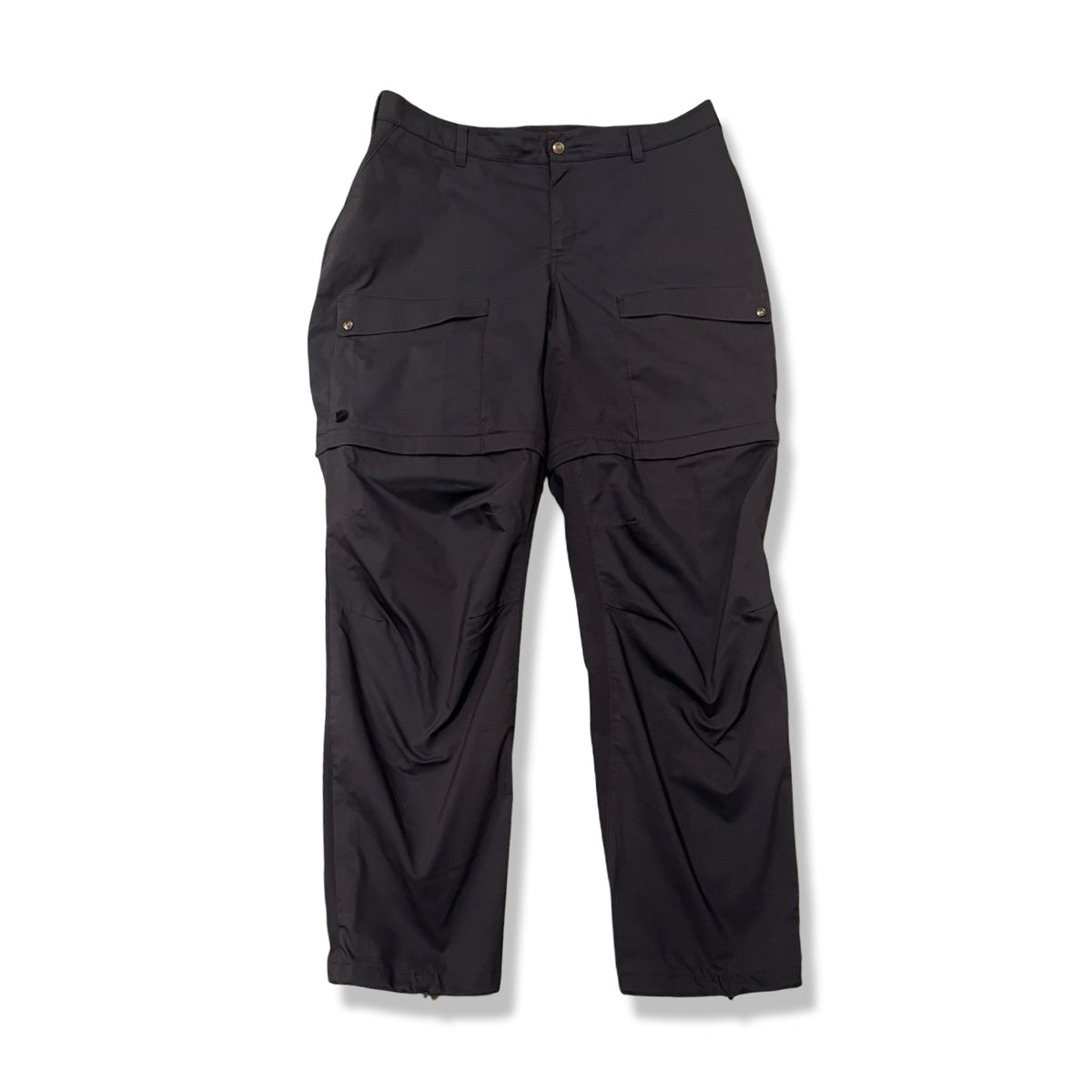 Mörkblå funktionsbyxa Fjällräven Abisko Hybrid Trail Trousers Zip-off för dam, fotograferad framifrån mot vit bakgrund.
