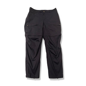 Mörkblå funktionsbyxa Fjällräven Abisko Hybrid Trail Trousers Zip-off för dam, fotograferad framifrån mot vit bakgrund.