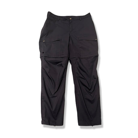 Mörkblå funktionsbyxa Fjällräven Abisko Hybrid Trail Trousers Zip-off för dam, fotograferad framifrån mot vit bakgrund.