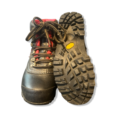 Lundhags Mira Mid vandringskängor i brunt läder med rött foder, där ena kängan visar den mönstrade Vibram-sulan.