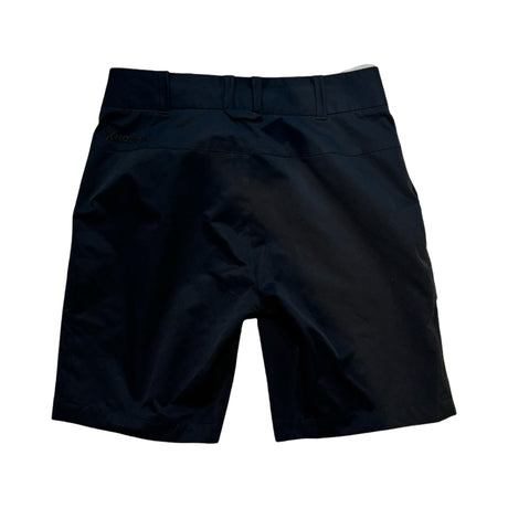 Svarta Houdini Go Shorts för dam, funktionella vandringsshorts sedda bakifrån mot vit bakgrund.